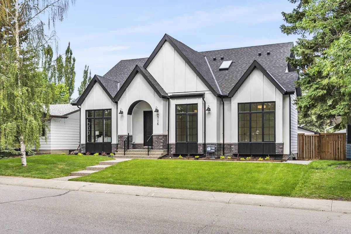 A new white two-storey infill with a front lawn